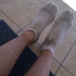 Socks and legs covered in Kalahari sand.