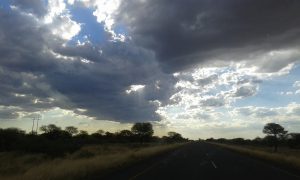 Sun finding its way through storm clouds near Sekoma after an afternoon of rain in Southern District, Botswana